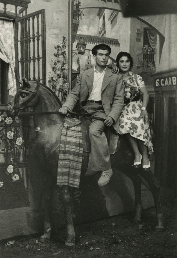 Couple posing in photographer's tent during the Feria de San Isidro by Inge Morath
